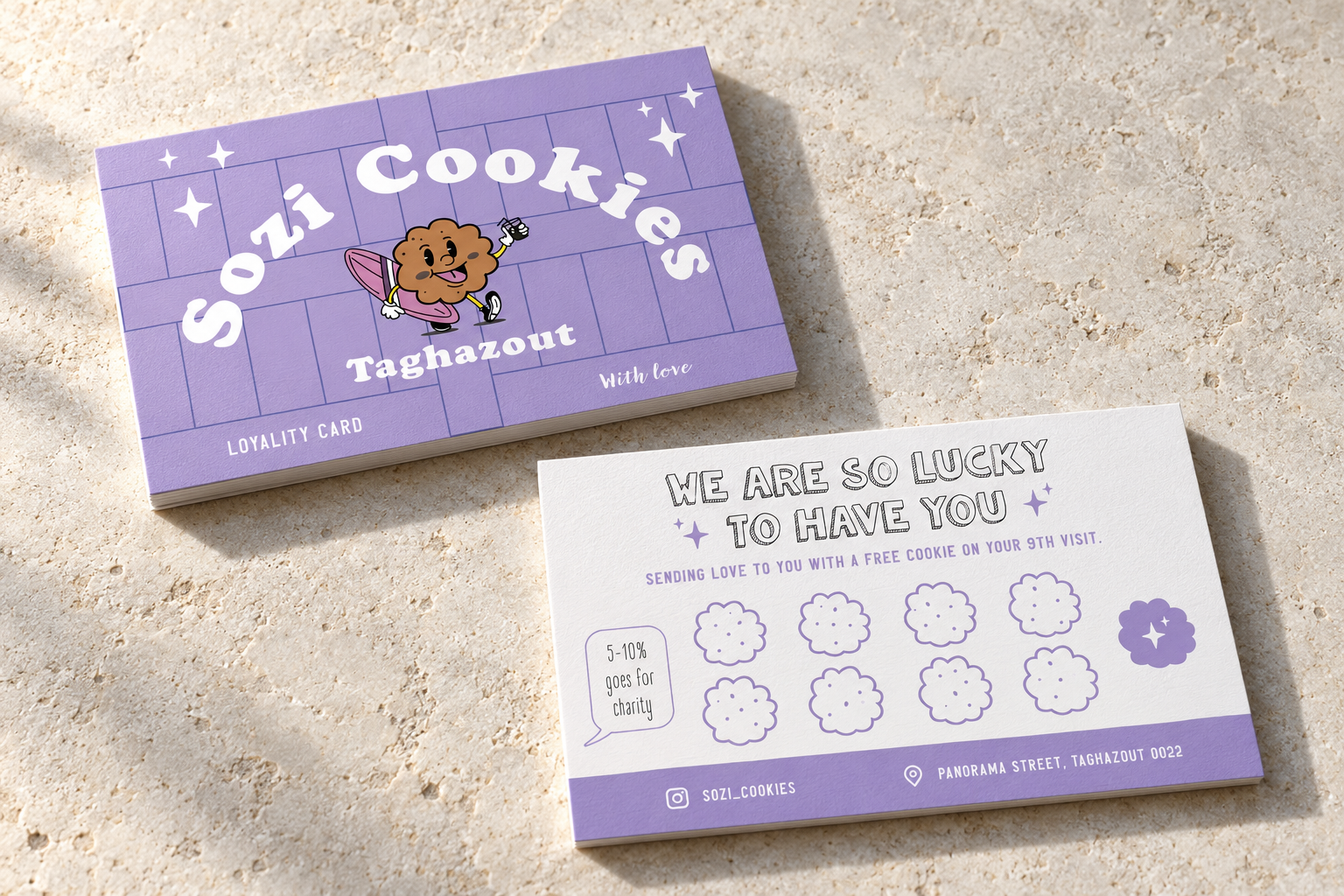 Front and back of the lilac Sozi Cookies loyalty card on pale limestone