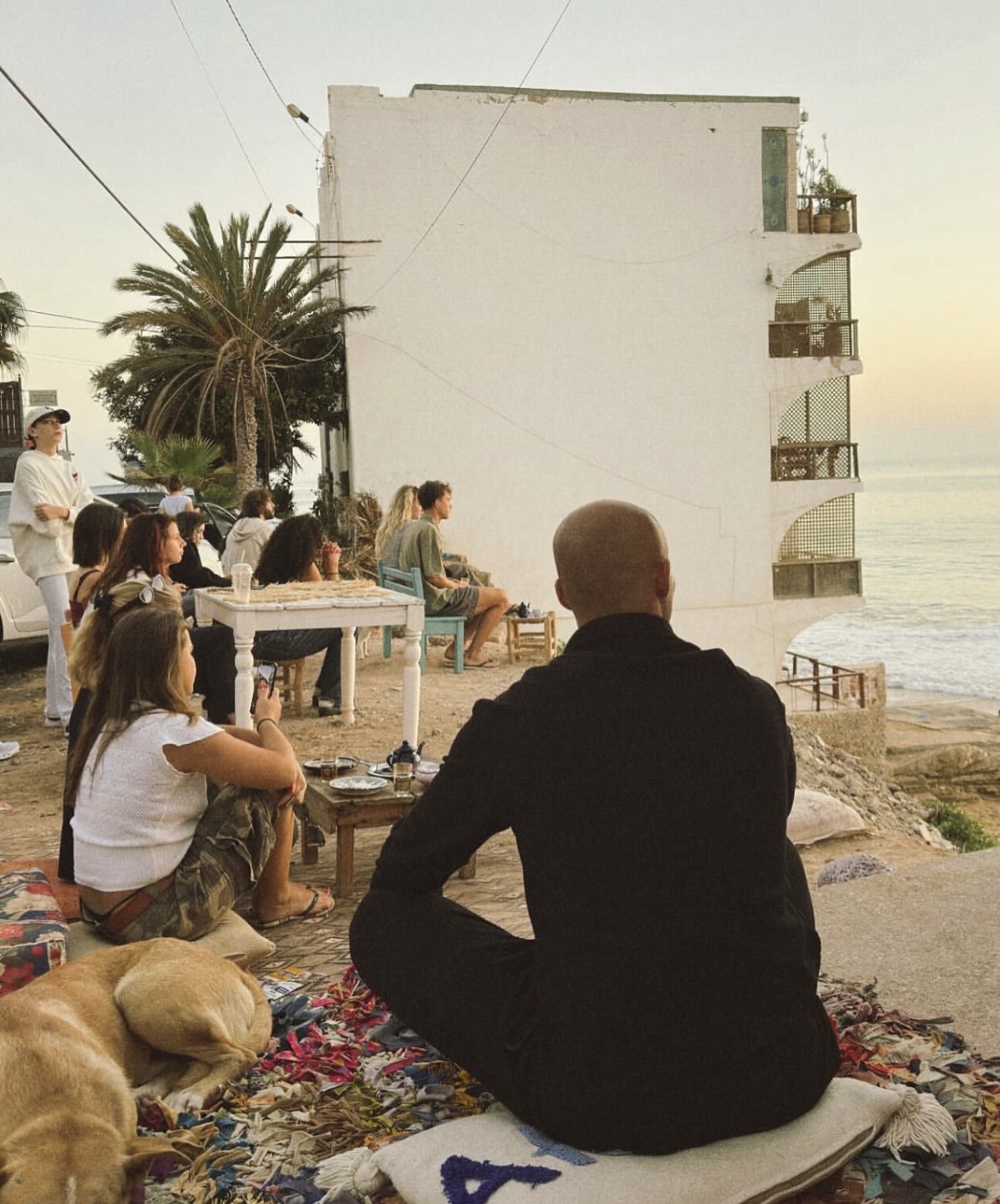 Guests enjoying the ocean view at sunset outside Sozi Cookies